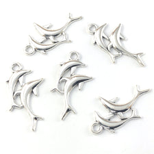 silver colour jewelry charms shaped like dolpins