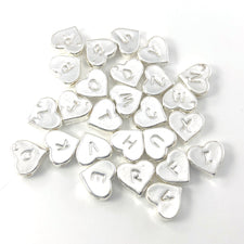 26 heart shaped silver colour beads with letters on them