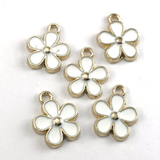 white and gold flower shaped jewelry charms