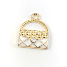 gold and white jewelry charms that look like purses