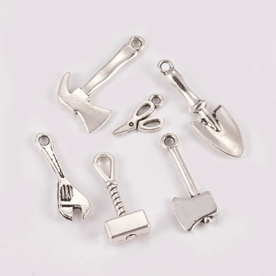 silver jewelry charms that look like hand tools